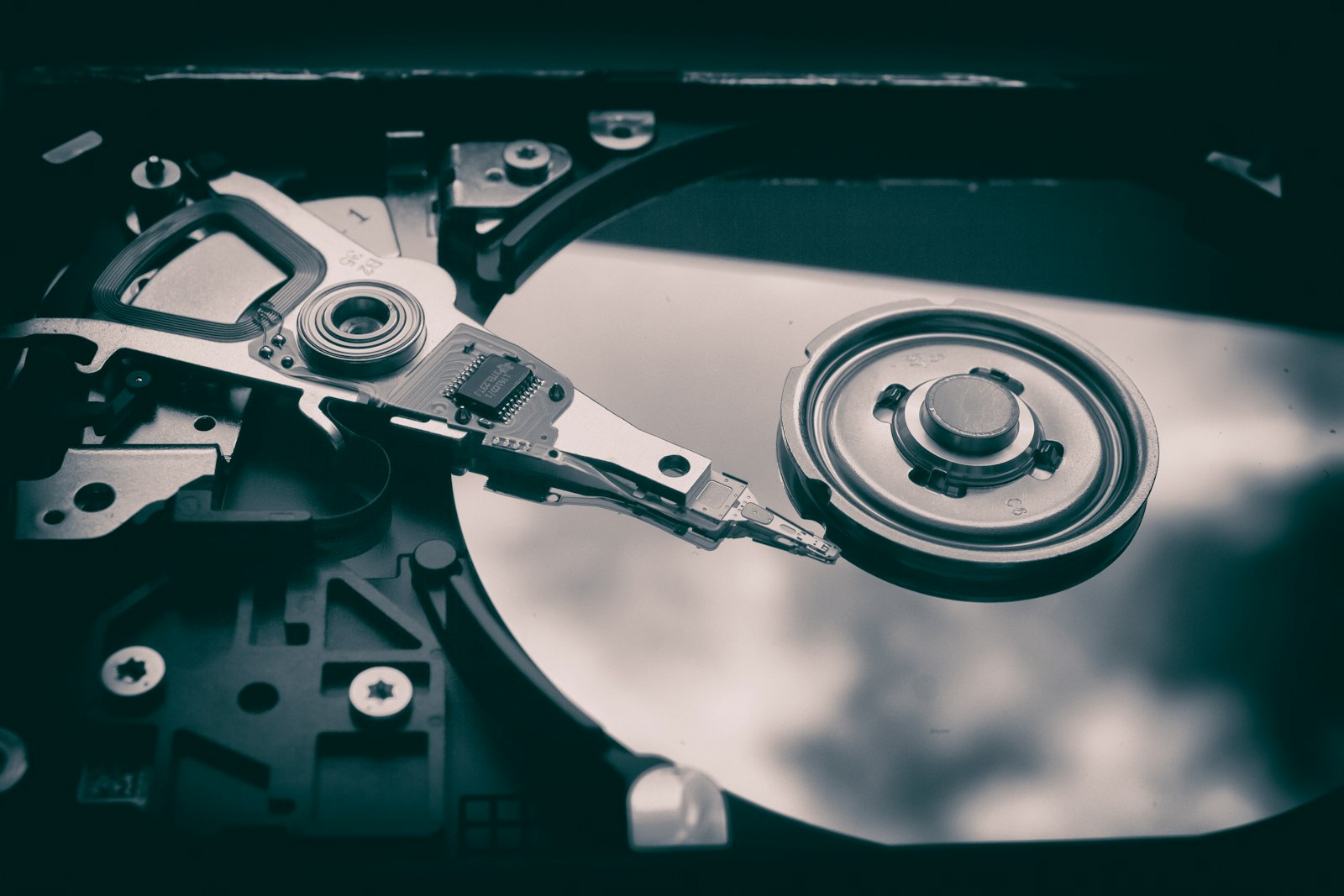 Inside of a hard disk drive with platter and actuator arm